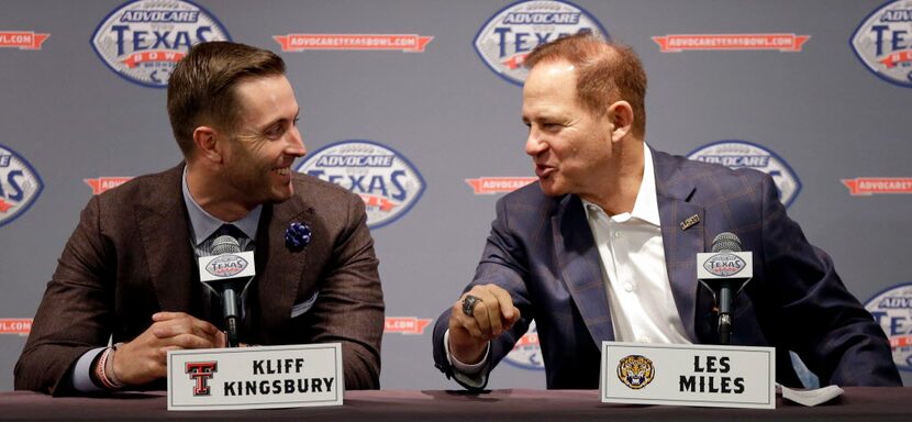 LSU coach Les Miles, right, talks with Texas Tech coach Kliff Kingbury's during a Texas Bowl...