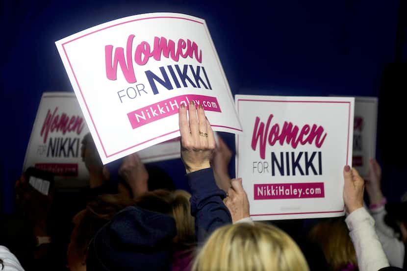 FILE - "Women for Nikki" volunteers wave signs ahead of an appearance by Republican...