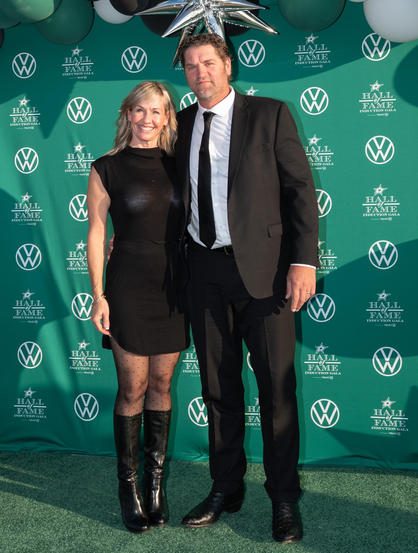 Former Dallas Stars player Derian Hatcher and his wife Heather Hatcher pose for photographs...