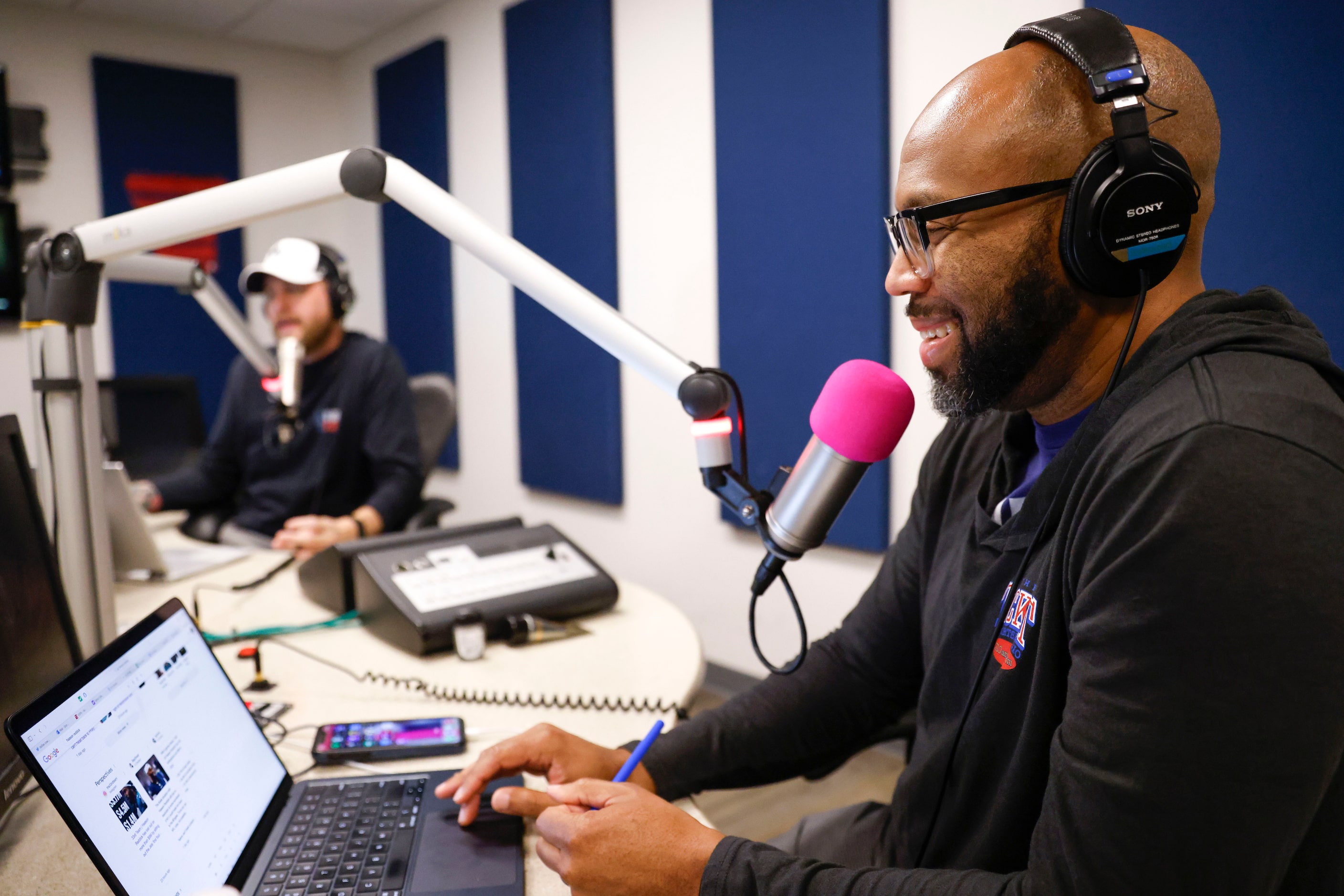  "The Ticket" co-host Donovan Lewis (front) holds a segment of The Invasion with Matt...