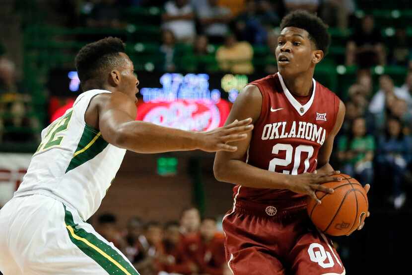 Baylor's King McClure defends as Oklahoma's Kameron McGusty (20) looks to make a pass in the...