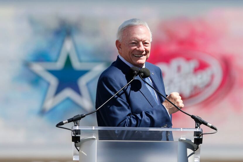 In front of the iconic brand logos of the Dallas Cowboys and DrPepper, Cowboys owner and...