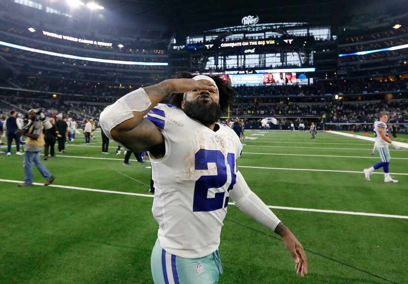 Dallas Cowboys running back Ezekiel Elliott (21) blows kisses to his family as he walks off...