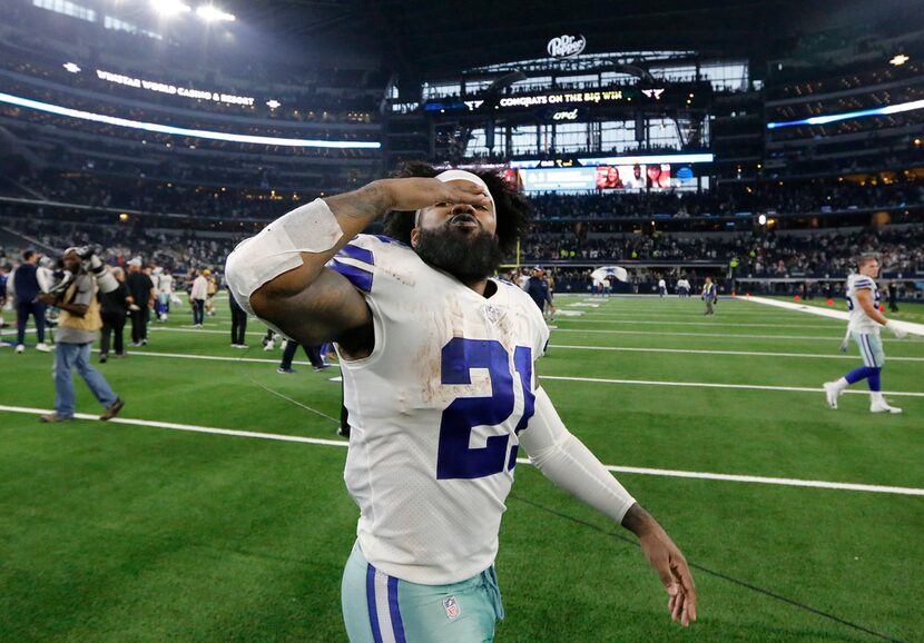 Dallas Cowboys running back Ezekiel Elliott (21) blows kisses to his family as he walks off...