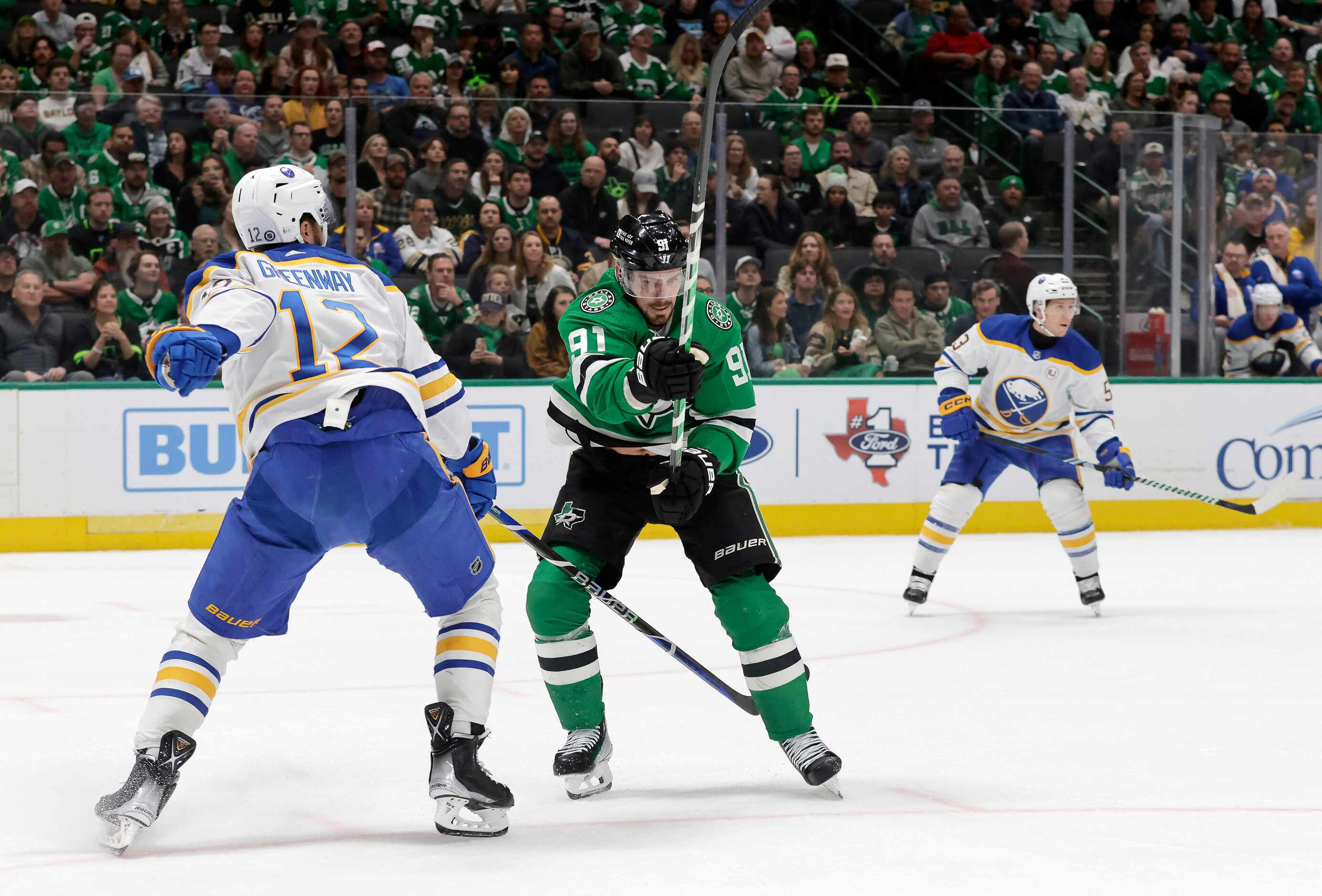 Dallas Stars center Tyler Seguin (91) flips the puck away from Buffalo Sabres left wing...