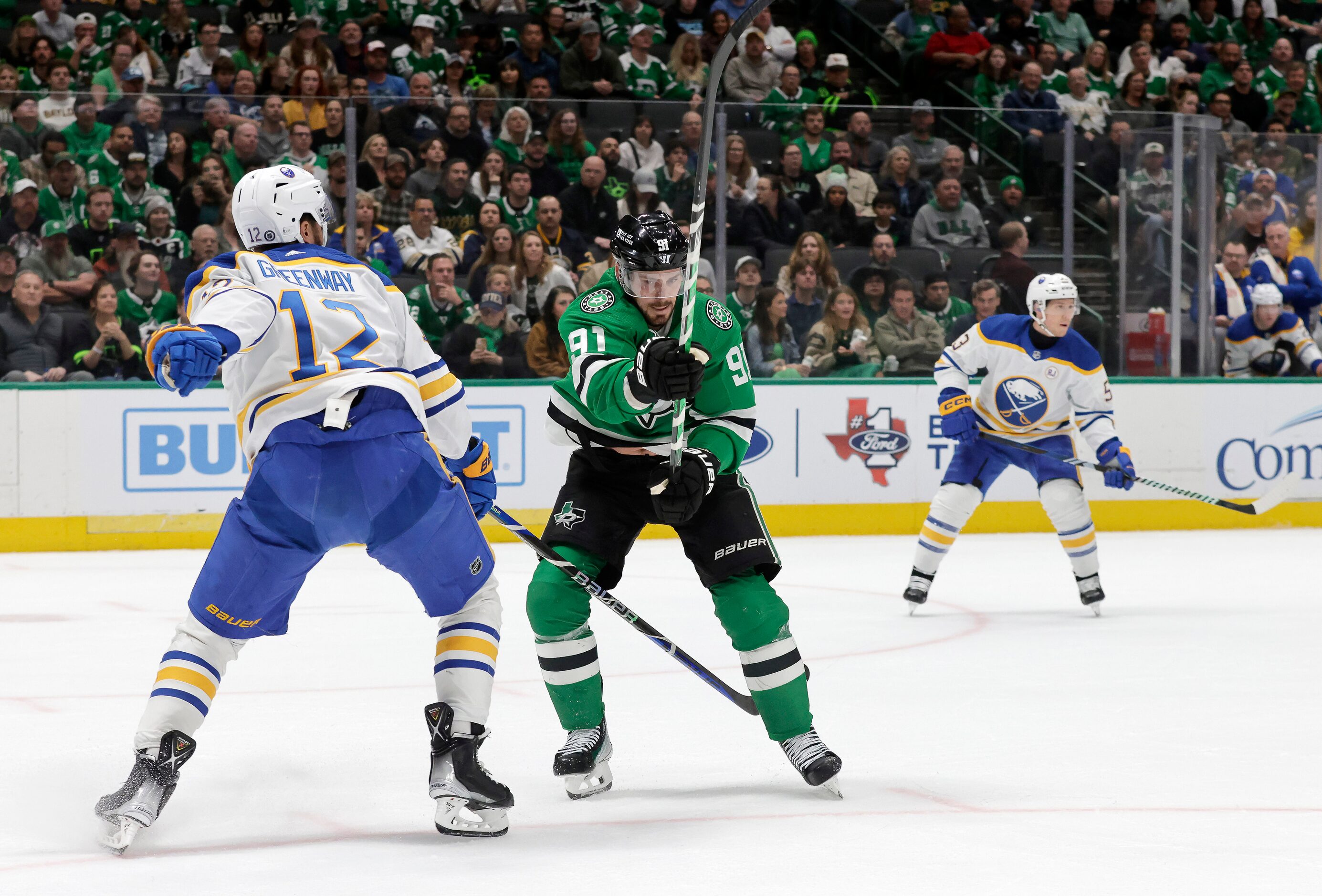 Dallas Stars center Tyler Seguin (91) flips the puck away from Buffalo Sabres left wing...