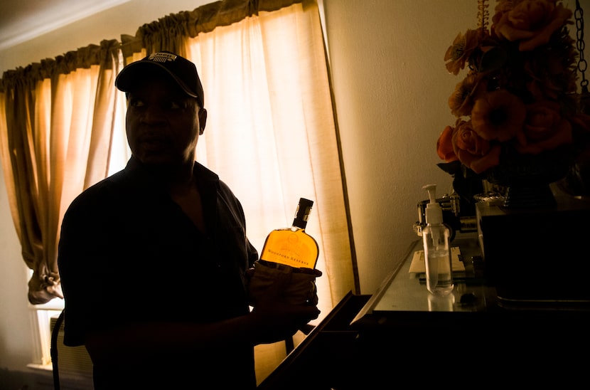 Martin Wilford, a relative of Richard Overton, pulls one of his cousin's whiskey bottles...