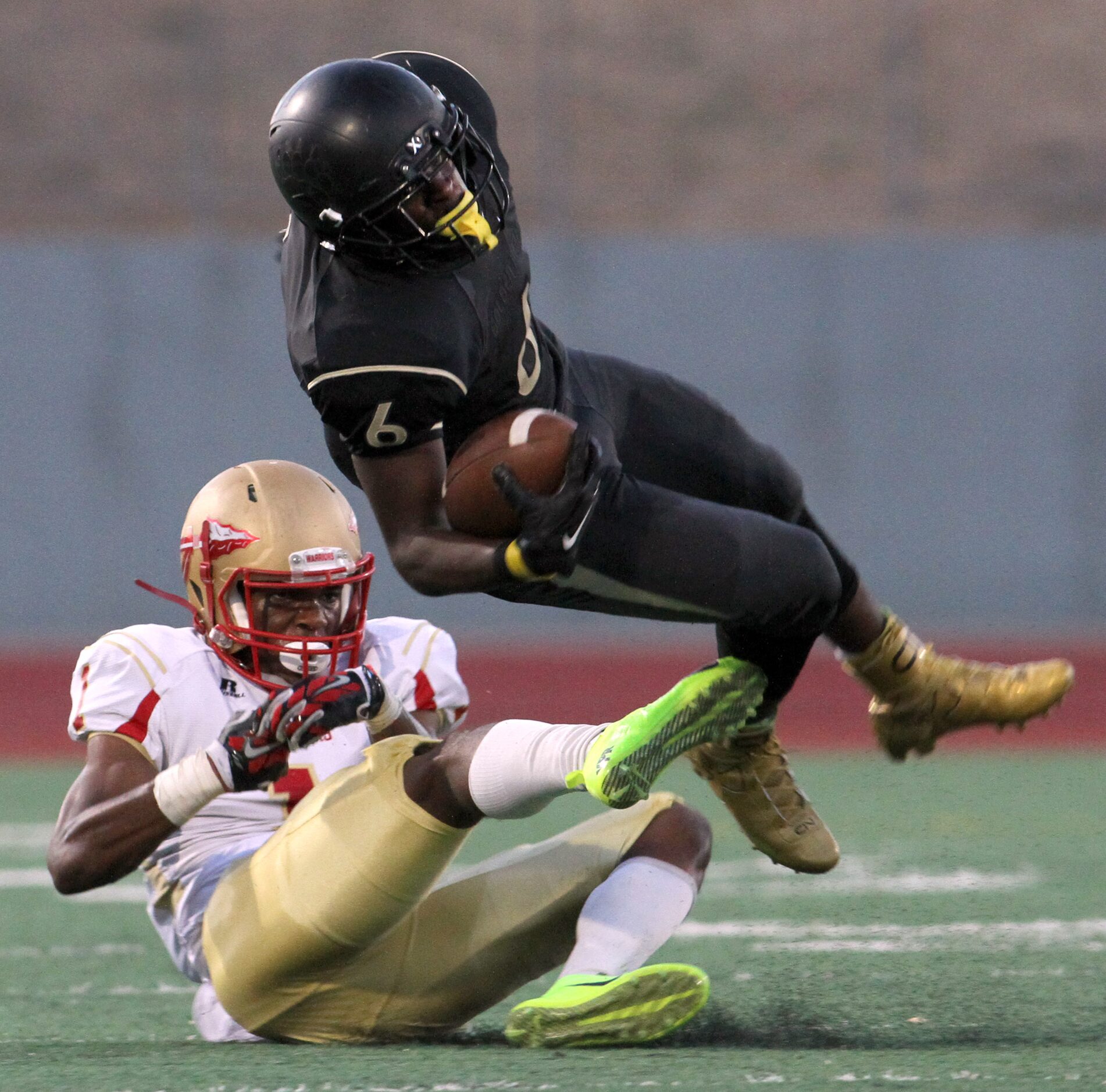 South Oak Cliff running back Jordan Ray (6) is tripped up by South Grand Prairie cornerback...