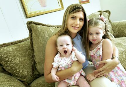 07/12/2004 ---  Tracy Woodall with children Pierce, 2, right, and Isabella, 8 months, has...