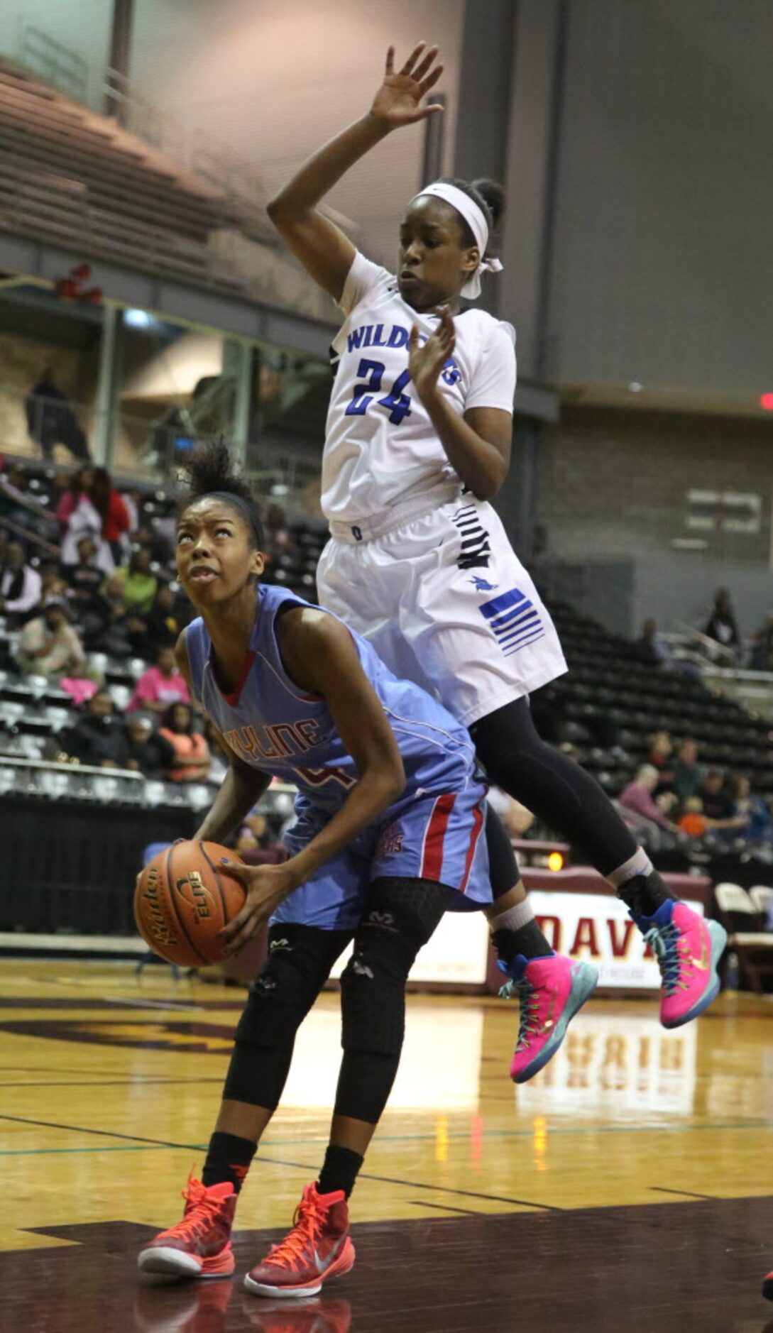 Skyline guard Raven Johnson (4)fights for position in the post against Dekaney's Lauren...