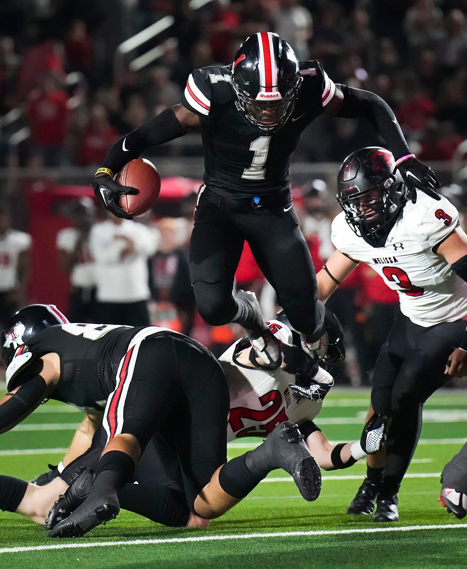 Lovejoy’s Kyle Parker (1) leaps over Melissa linebacker Landen Brandow (25) during the first...