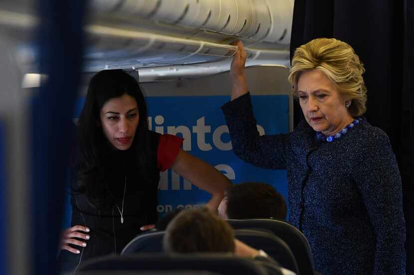 Democratic presidential nominee Hillary Clinton and top aide Huma Abedin (left) talk to...