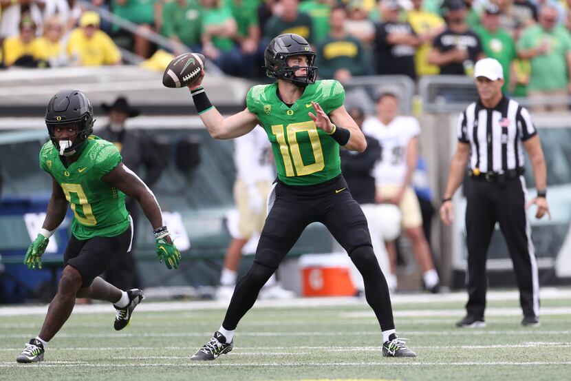Oregon quarterback Bo Nix looks to pass against Colorado during the first half of an NCAA...