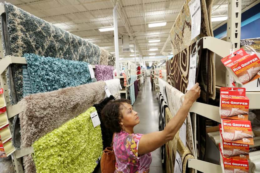 Martha Smith, of Carrollton, shops for rugs inside an At Home location on Stemmons Freeway...