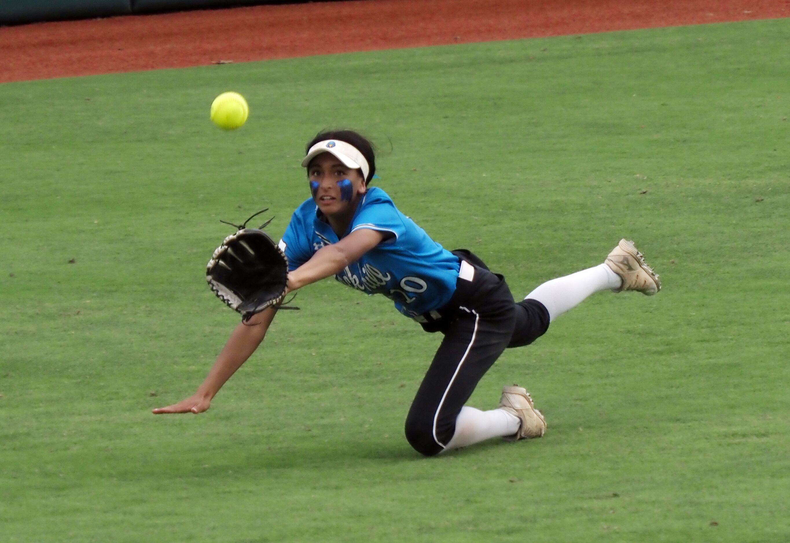 Prosper Rock Hill center fielder Veronica Cully dives for a fly ball against Montgomery Lake...