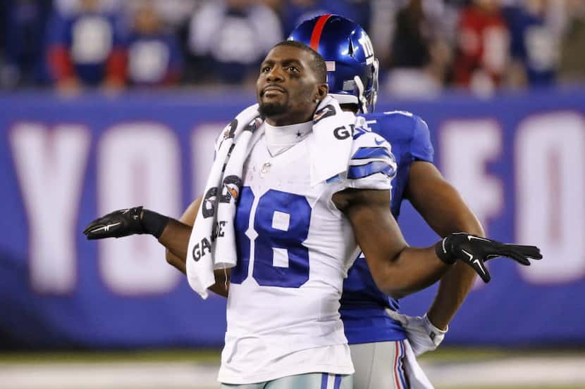Dallas Cowboys wide receiver Dez Bryant (88) signals the Giants' last gasp try for a first...