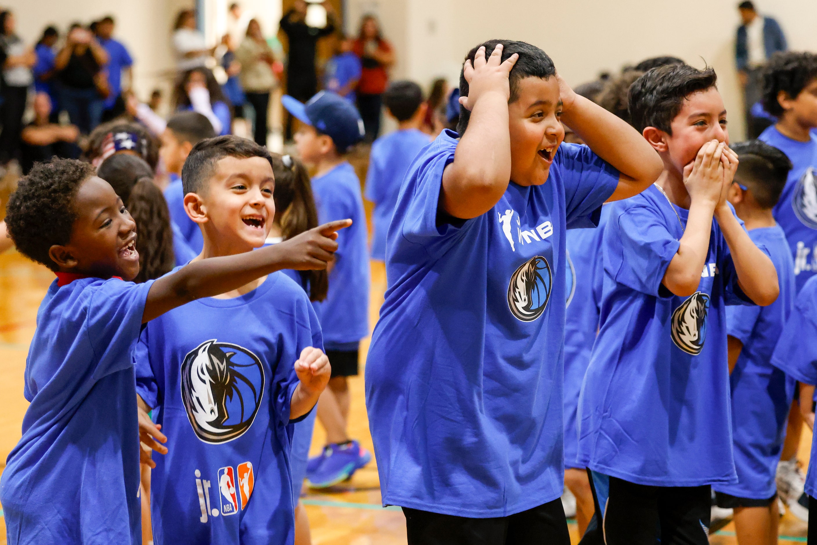 Kids react as Dallas Mavericks guard Luka Doncic enters a children’s basketball clinic along...