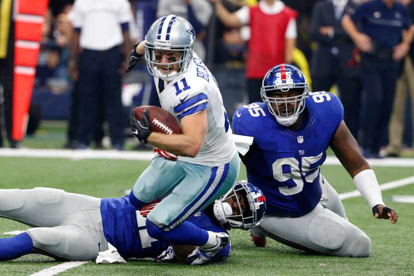 Dallas Cowboys wide receiver Cole Beasley (11) fights for extra yardage as New York Giants...