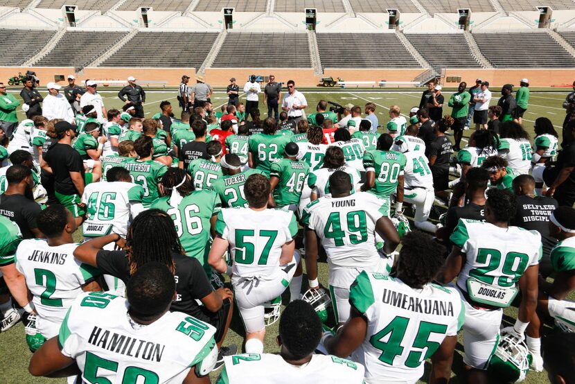 North Texas head coach Seth Littrell gathers his team for a talk after the Green-White...