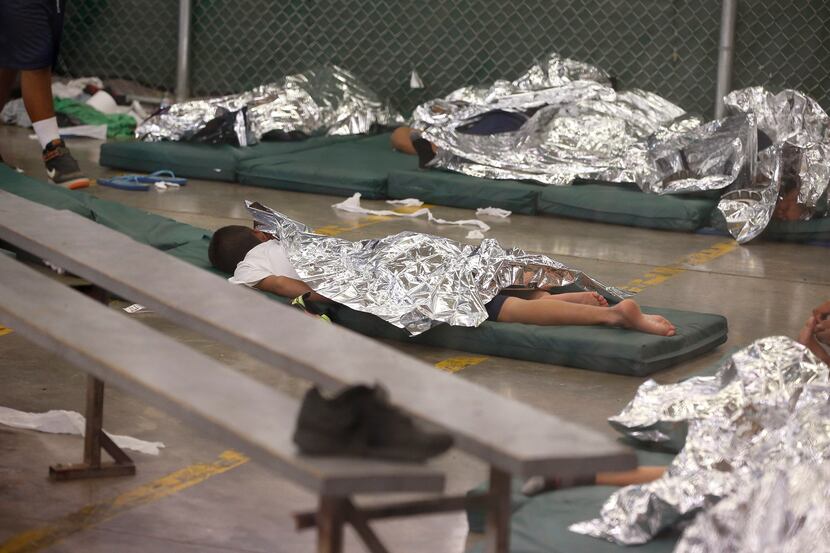 Young boys sleep in a holding cell where hundreds of mostly Central American immigrant...