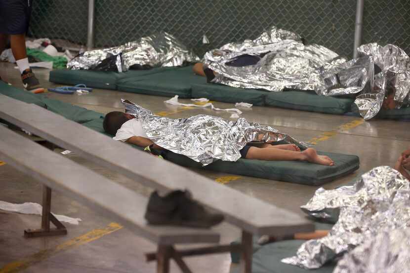 Young boys sleep in a holding cell where hundreds of mostly Central American immigrant...