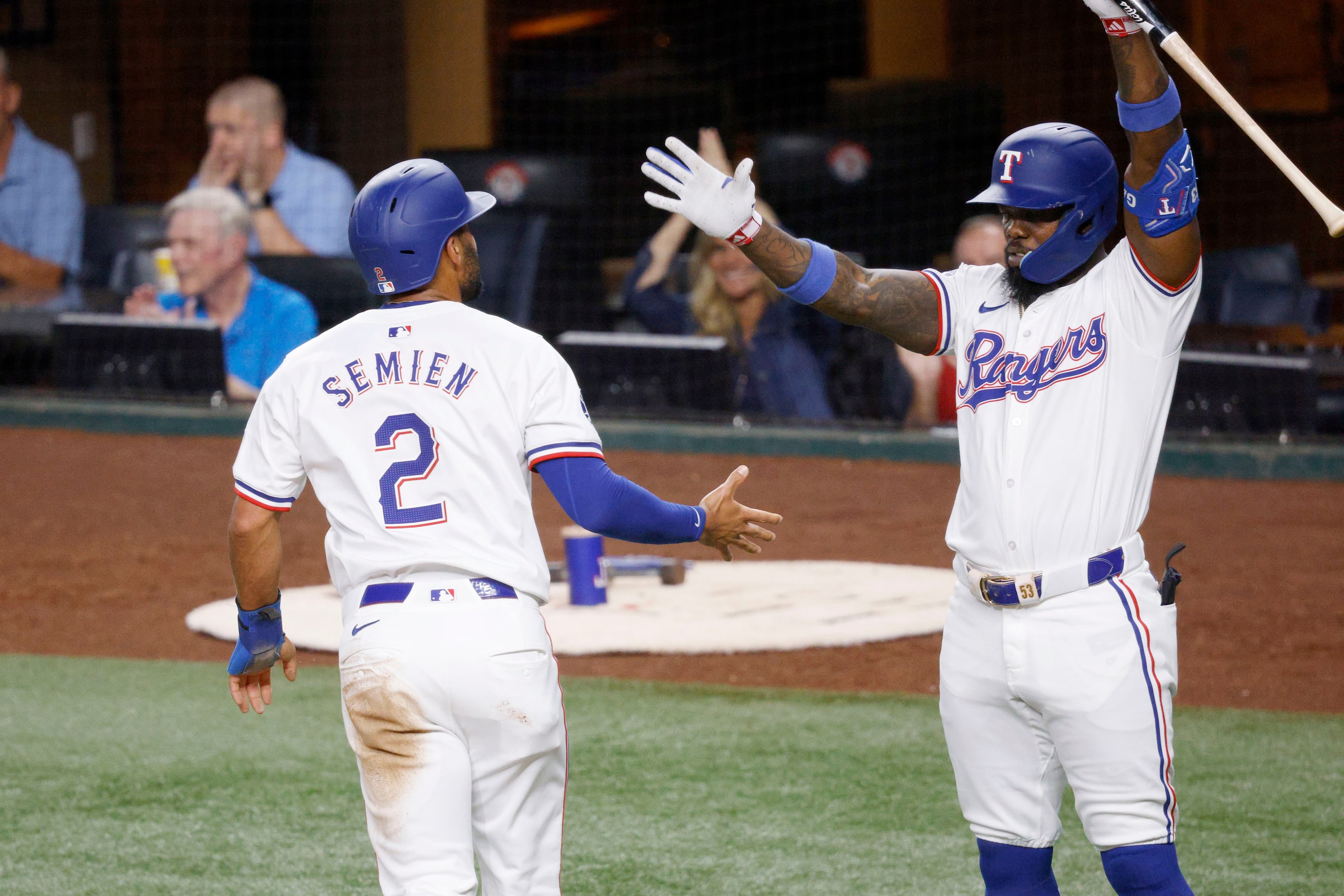 Texas Rangers second base Marcus Semien (2) gets a high-five from his teammate Texas Rangers...