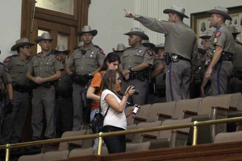 State troopers entered the gallery to try to restore order after the special session ended...