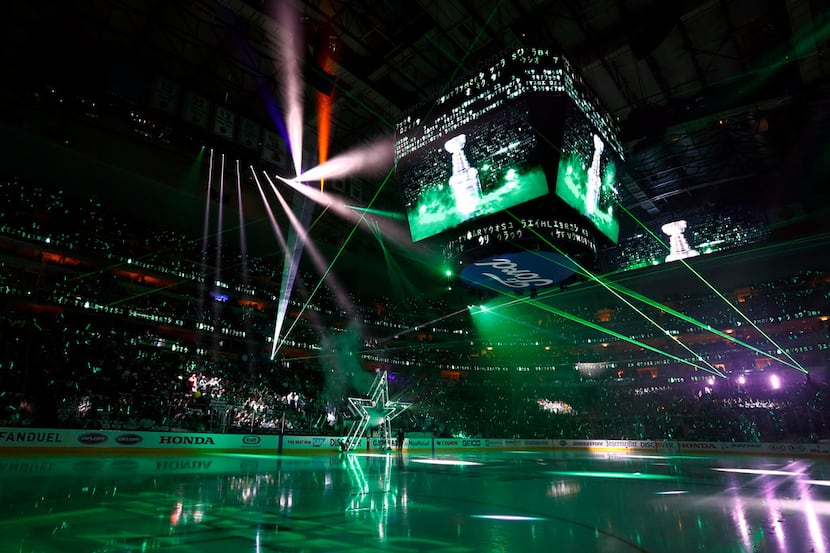 Fans look on during a laser light show before team introductions in Game 4 in an NHL hockey...
