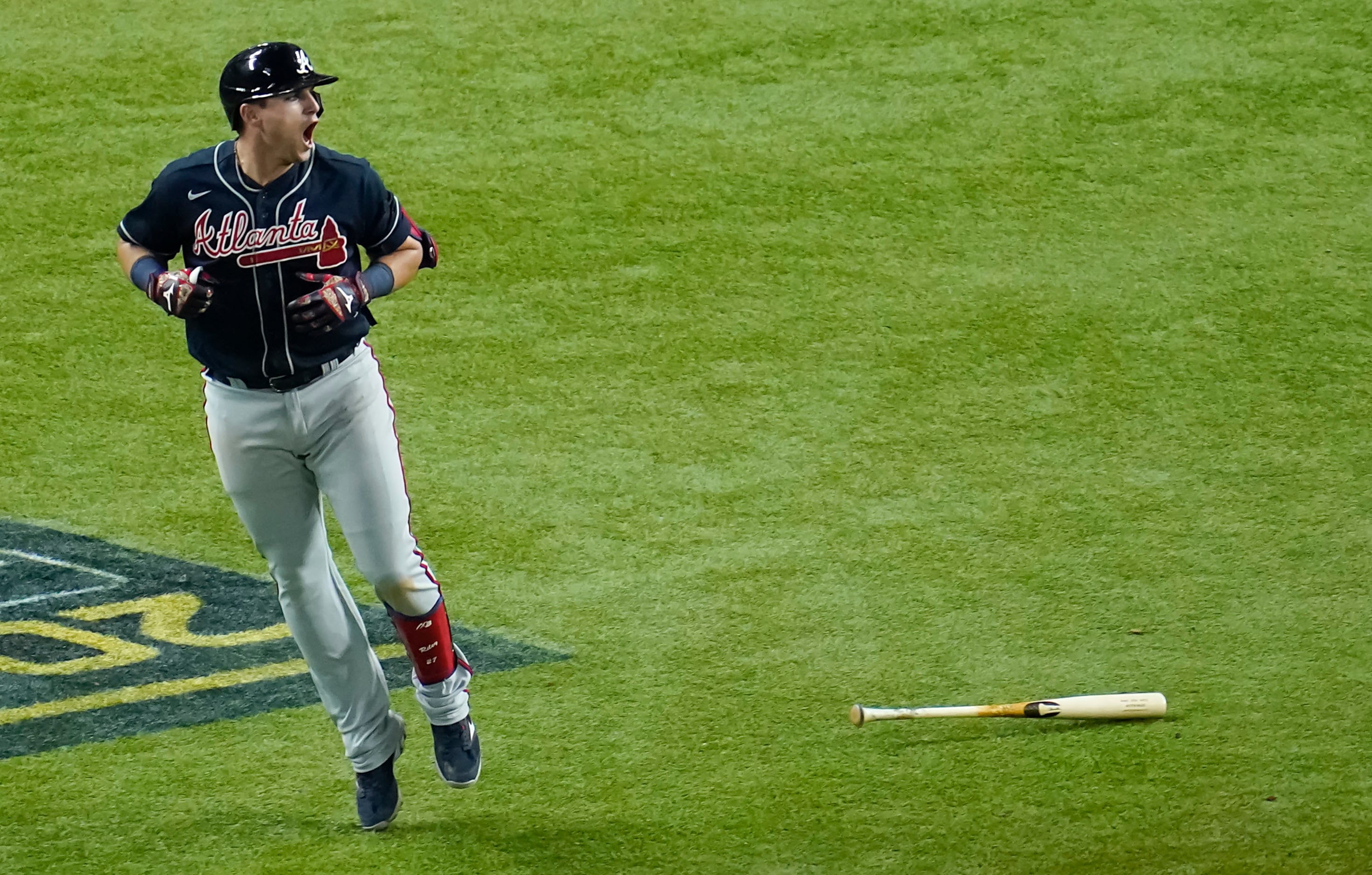 Atlanta Braves third baseman Austin Riley celebrates as he watches a solo home run sail over...