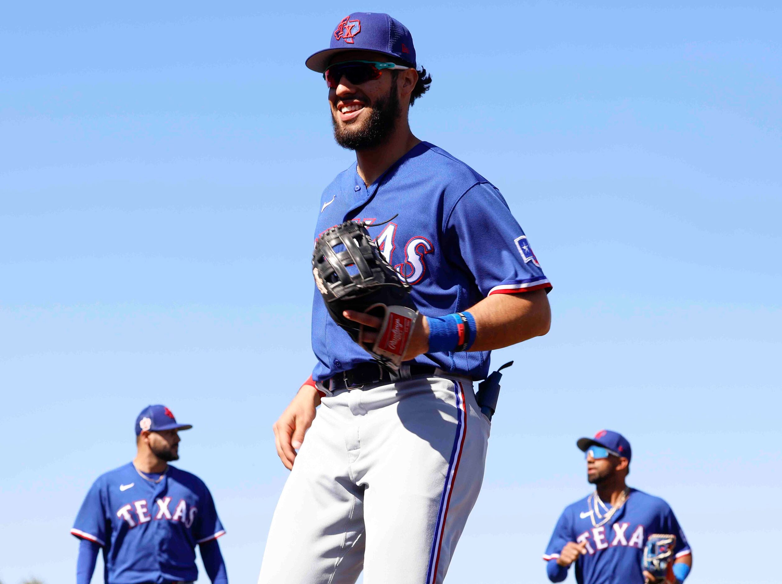 Texas Rangers infielder Jonathan Ornelas (center), pitcher Martín Pérez, (left) and...