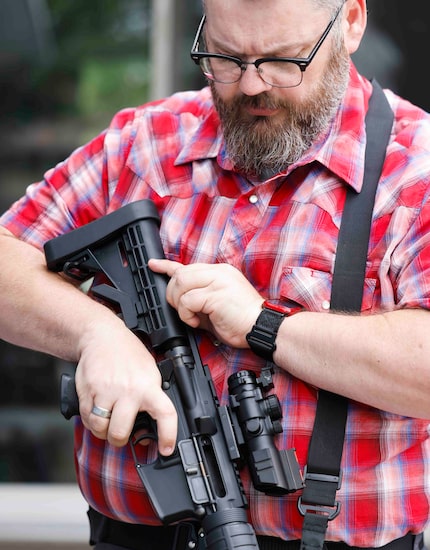 Duncanville High School Collegiate Academy teacher Glynn Wilcox shows his AM-15 at his home...