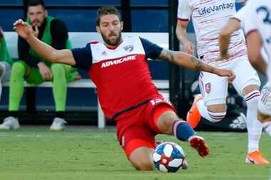 FC Dallas midfielder Ryan Hollingshead (12) slides to get a pass off during the first half...