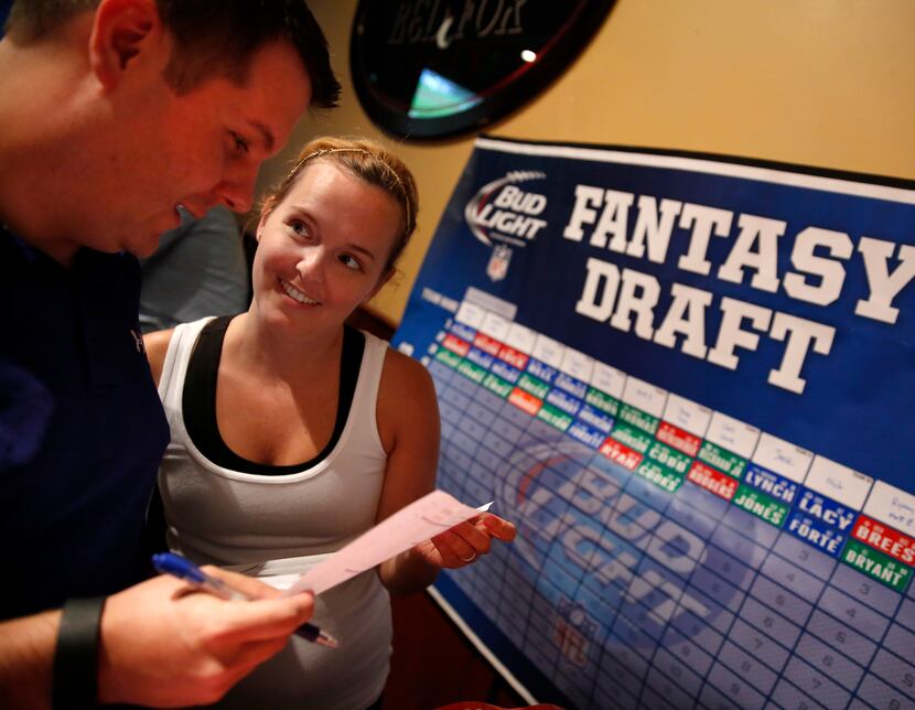 Chris Auwarter (left) makes his third round pick in aFantasy Football Draft at the Fox and...