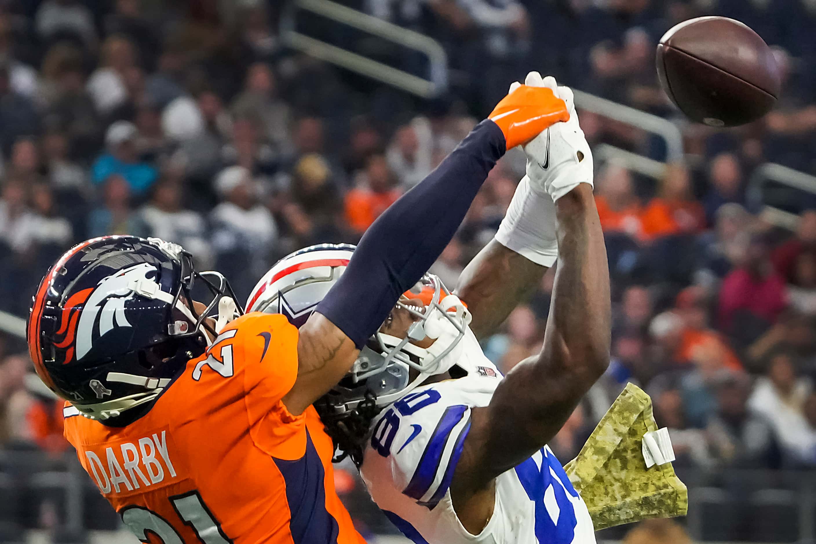 Dallas Cowboys running back Ezekiel Elliott (21) is knocked off his feet by Denver Broncos...