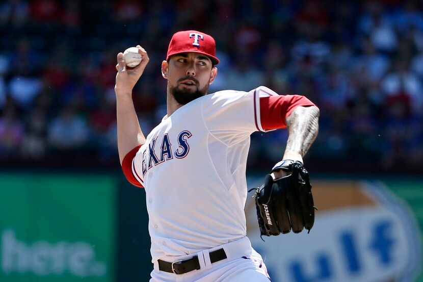 Texas Rangers Anthony Ranaudo works against the Los Angeles Angels in the first inning of a...