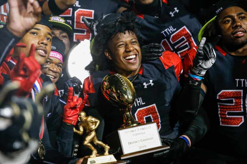 The Cedar Hill Longhorns celebrate their 7-6A district championship win over the DeSoto...