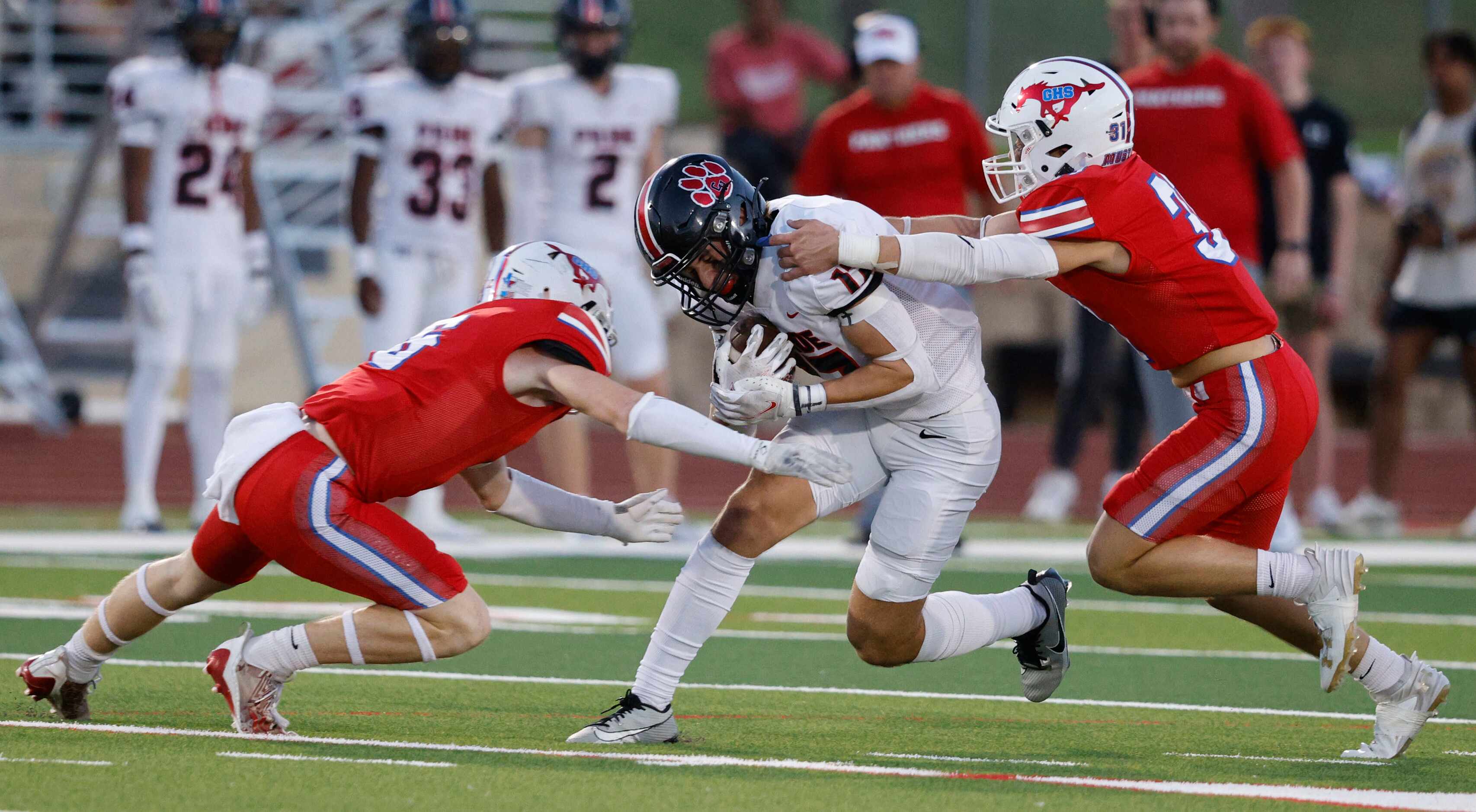Grapevine's Major Heckt (6) and Grapevine's Cooper Towery (31) go to stop Colleyville...