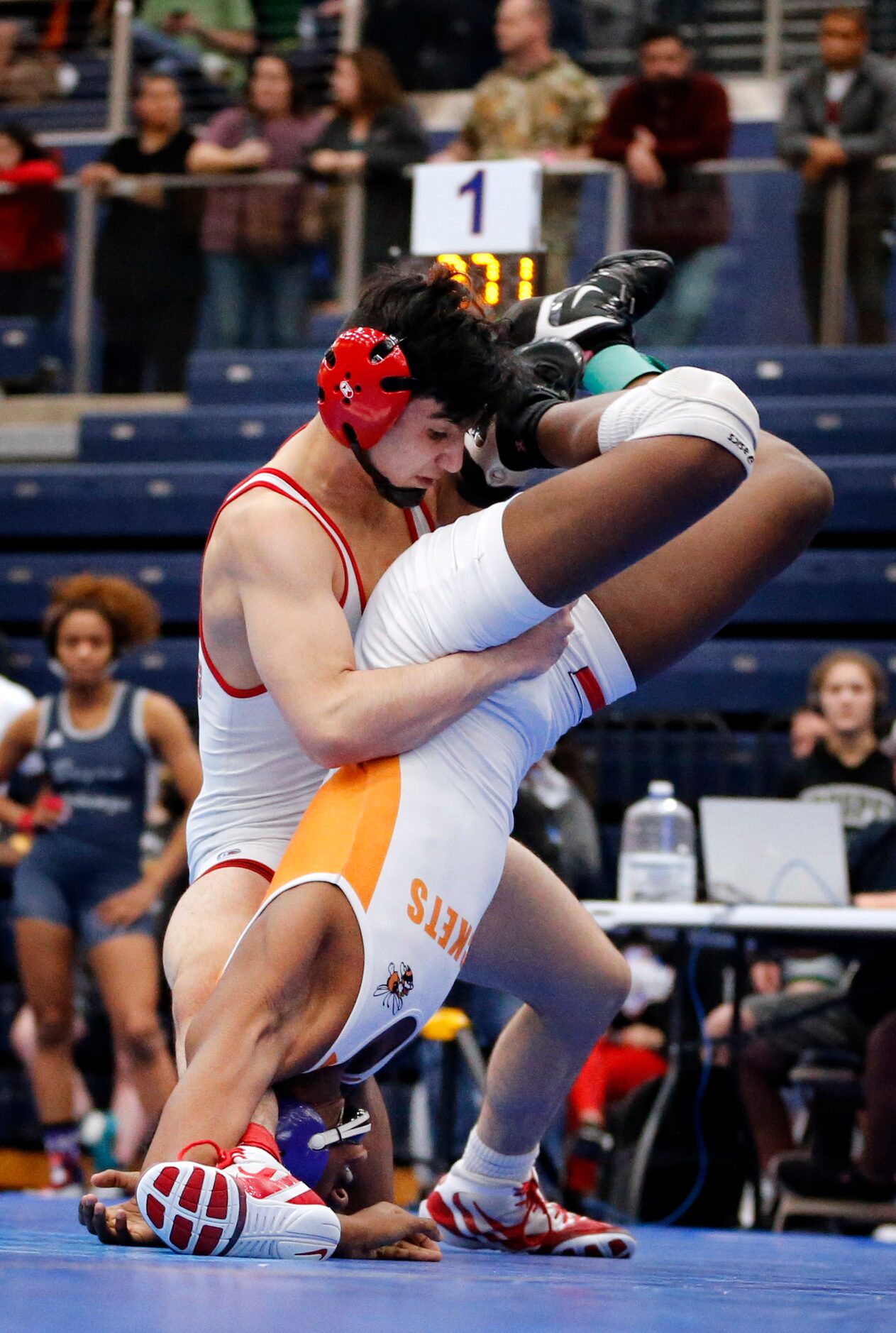 Allen High wrestler Kade Moore (left) battles Rockwall's Zach Flowers during their 120-pound...