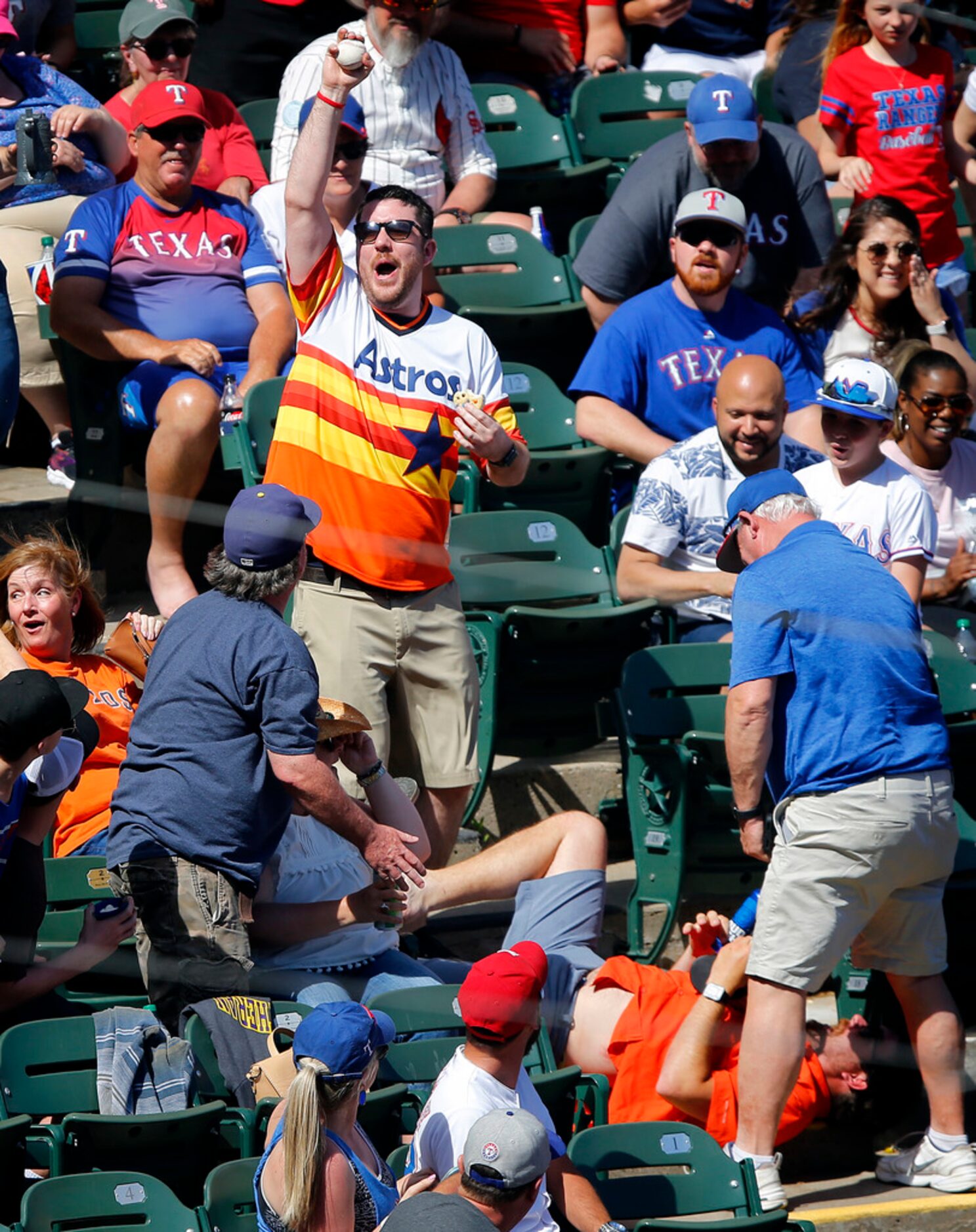 Series 4 of 4 -- The second Houston Astros fan celebrates with the ball after taking it from...