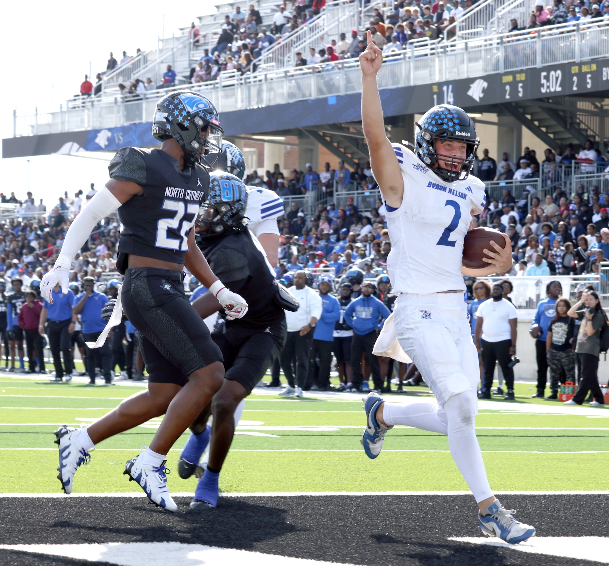 Byron Nelson quarterback Grant Bizjack (2), right, scores a rushing touchdown as North...