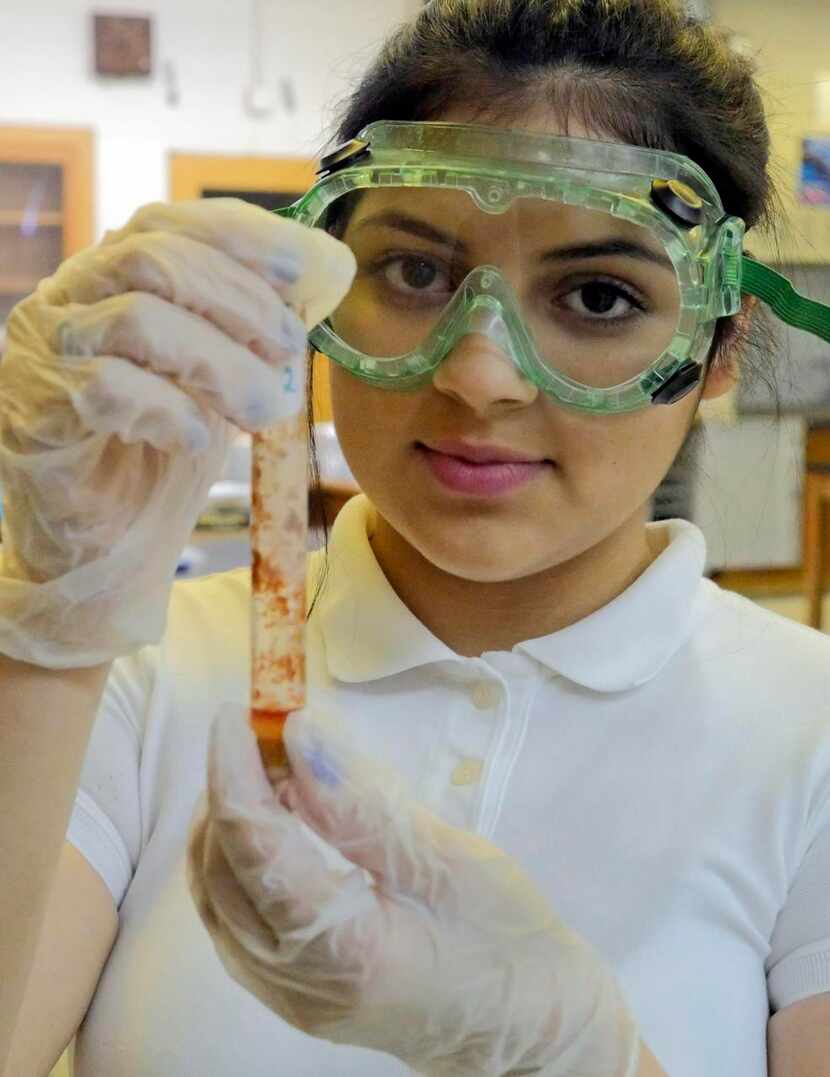 
Biotechnical engineering student Kenia Pereznegron, 16, holds up a test tube from the oil...