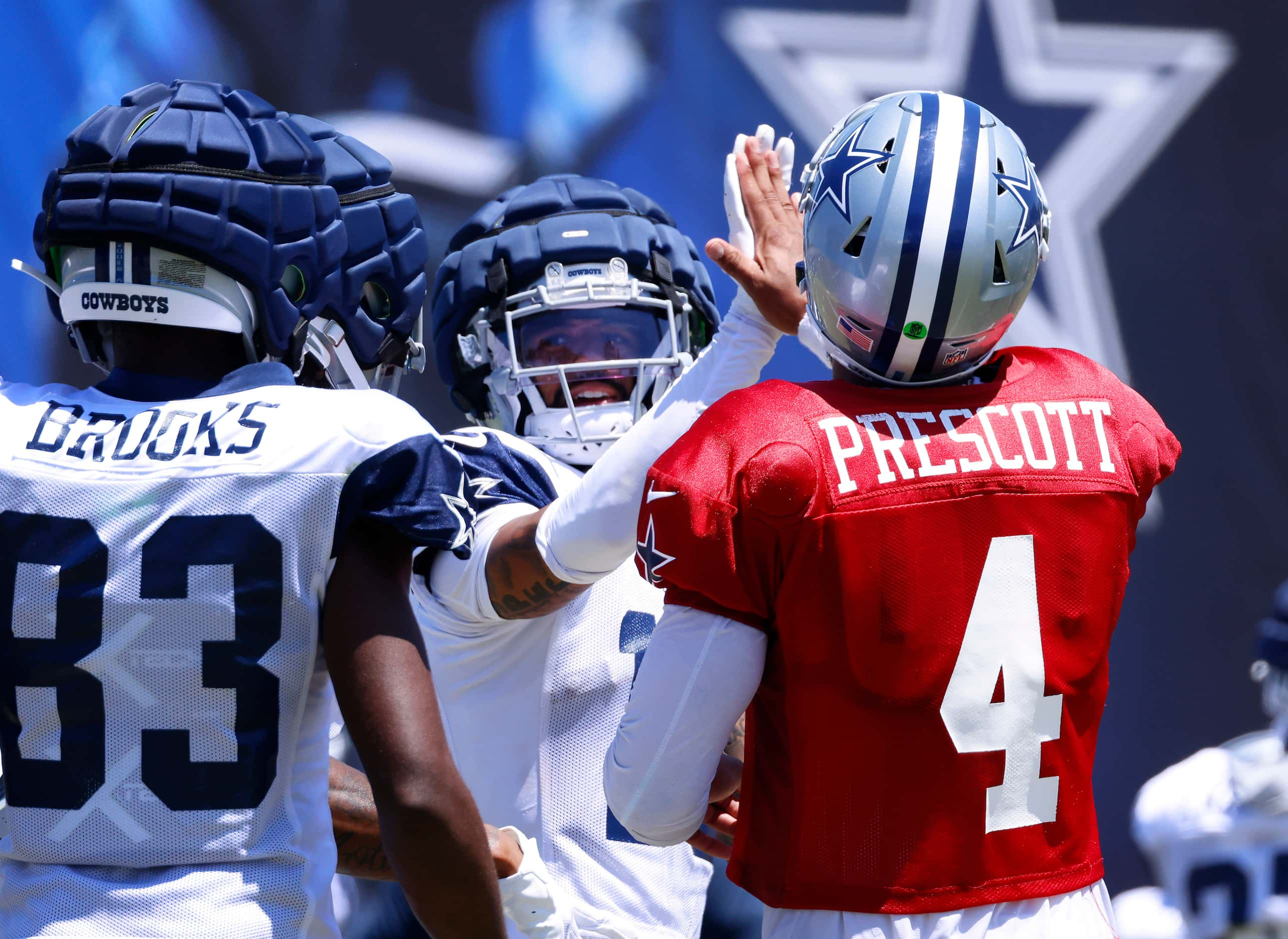 Dallas Cowboys quarterback Dak Prescott (4) high-fives wide receiver Jalen Moreno-Cropper...