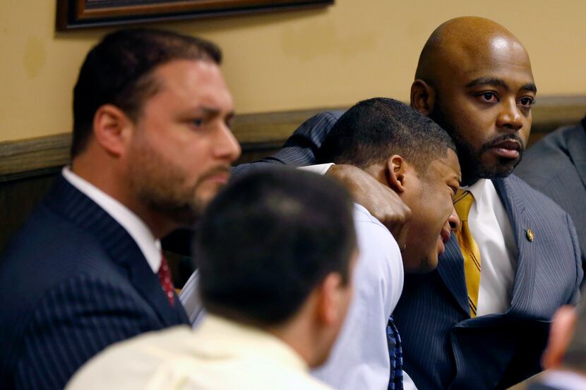 Defense attorney Walter Madison, right, holds his client, 16-year-old Ma'Lik Richmond,...