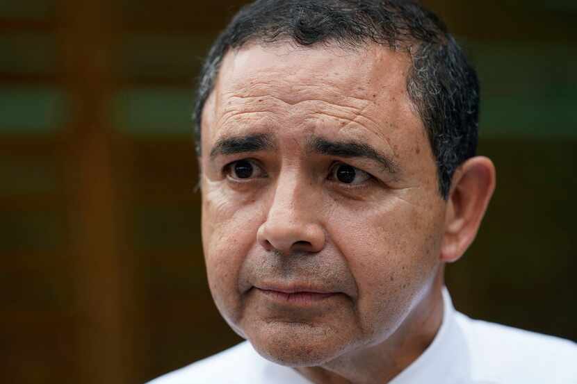 FILE - Rep. Henry Cuellar, D-Laredo, talks to a member of the media during a campaign event...