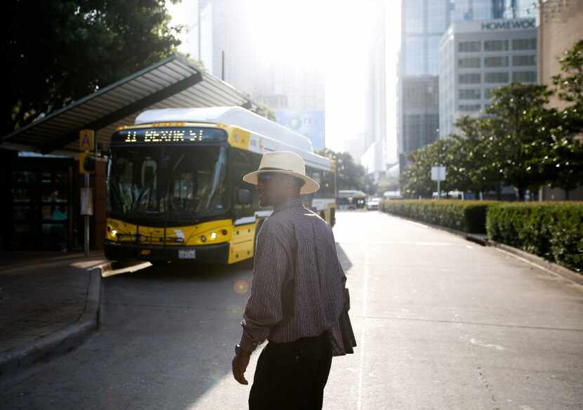 Joshua Miller crosses the street to a bus facility. He spends much of his day traveling on...