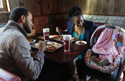 Anthony and Autumn Balfour sit with their baby, Fallon, 5-month old, while enjoying a free...