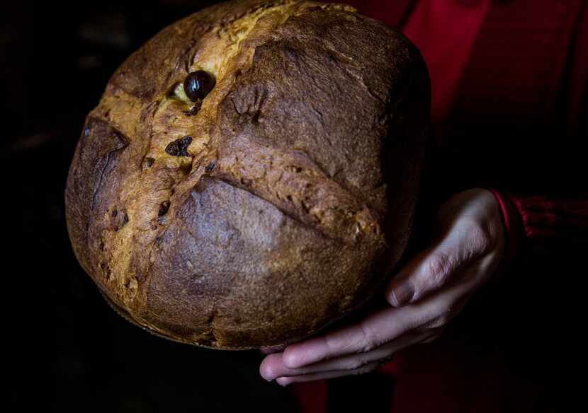 Employee Mila Alvarado holds a panettone at Jimmy's Food Store.