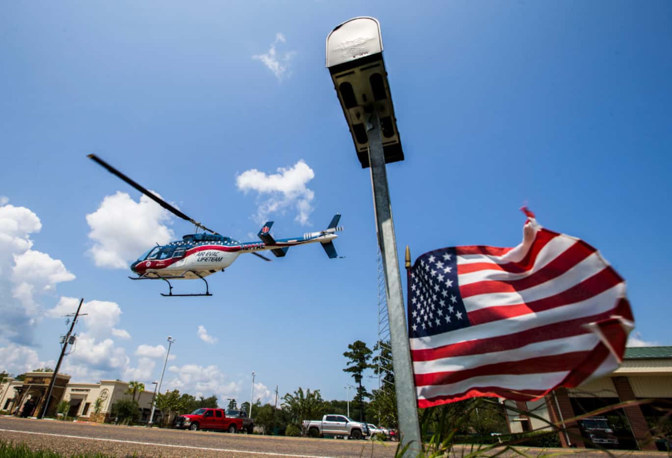Medical helicopters land in front of the Lumberton Central Fire Department to carry critical...