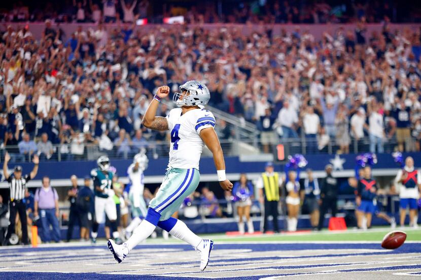Dallas Cowboys quarterback Dak Prescott (4) celebrates his touchdown run against the...