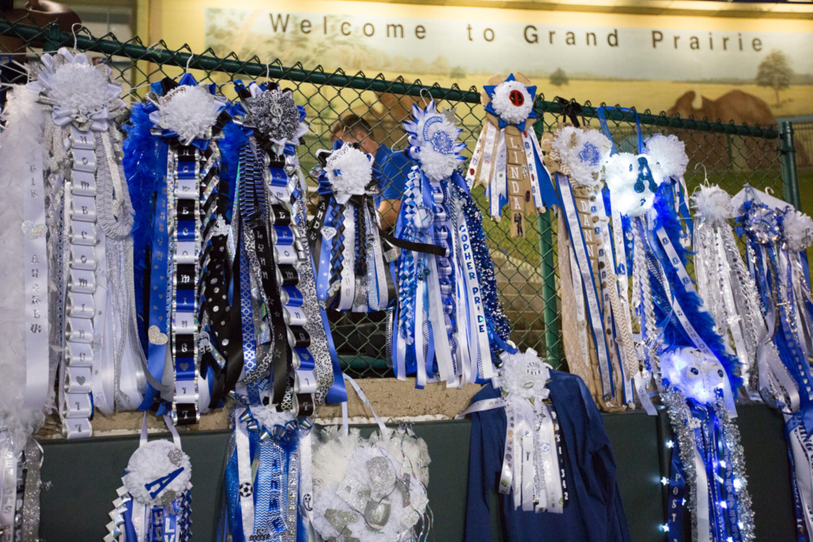 Homecoming mums line the fence during a District 7-6A matchup between Irving MacArthur and...